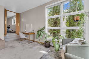 Living area featuring carpet and baseboards