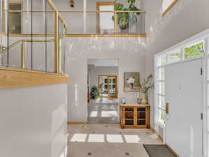 Entrance foyer with a towering ceiling and light tile patterned floors