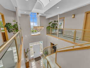 Foyer entrance with a high ceiling, recessed lighting, a chandelier, baseboard heating, and stairway