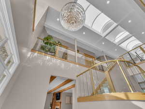 Detailed view of recessed lighting, a chandelier, and beamed ceiling