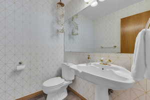 Bathroom with tile walls and toilet