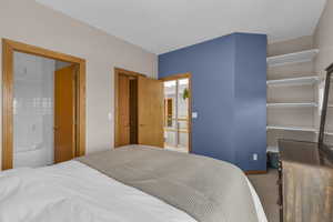 Bedroom with carpet flooring, connected bathroom, and a closet