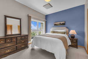 Bedroom featuring light colored carpet and baseboards