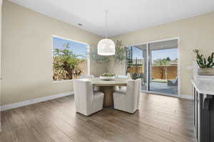Dining space featuring baseboards and light wood-style floors