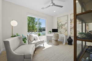 Living area with recessed lighting, a ceiling fan, a desk, and carpet