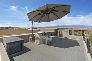 Roof top wooden terrace featuring a mountain view