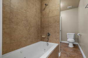 Full bath with toilet and a combined bath / shower with jetted tub
