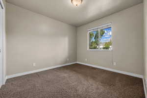 Spare room with carpet floors and baseboards