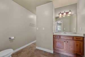 Half bathroom with vanity and light tile patterned floors