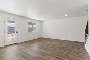 Foyer with light wood-style flooring, a textured ceiling, stairway, and recessed lighting