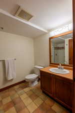 Full bathroom featuring a shower stall, vanity, a textured ceiling, and light tile patterned flooring