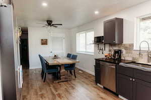 Dining area/Eat in kitchen with laminate floors, dishwasher, decorative backsplash, ceiling fan, and recessed lighting