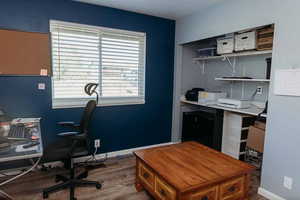 Home office/bedroom 3 featuring laminate floors and closet organizer