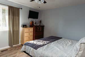 Master bedroom featuring laminate floors and ceiling fan