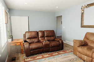 Living room with laminate floors and recessed lighting
