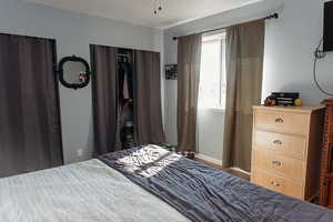 Master bedroom with laminate floors, double closets, ceiling fan