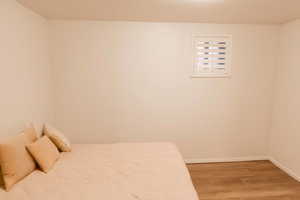 Bedroom featuring light wood finished floors and baseboards