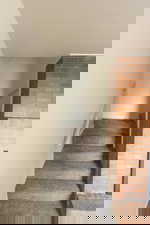 Stairway with baseboards and carpet flooring