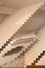 Washroom featuring washer / dryer and baseboards