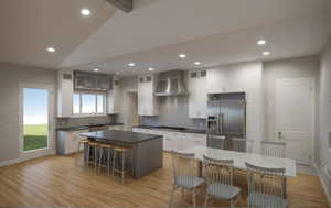 Kitchen featuring a kitchen bar, dark countertops, white cabinetry, appliances with stainless steel finishes, and recessed lighting