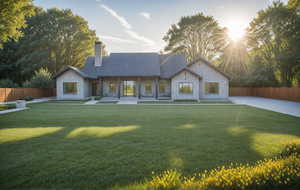 View of front facade featuring stone siding, a chimney, and a patio