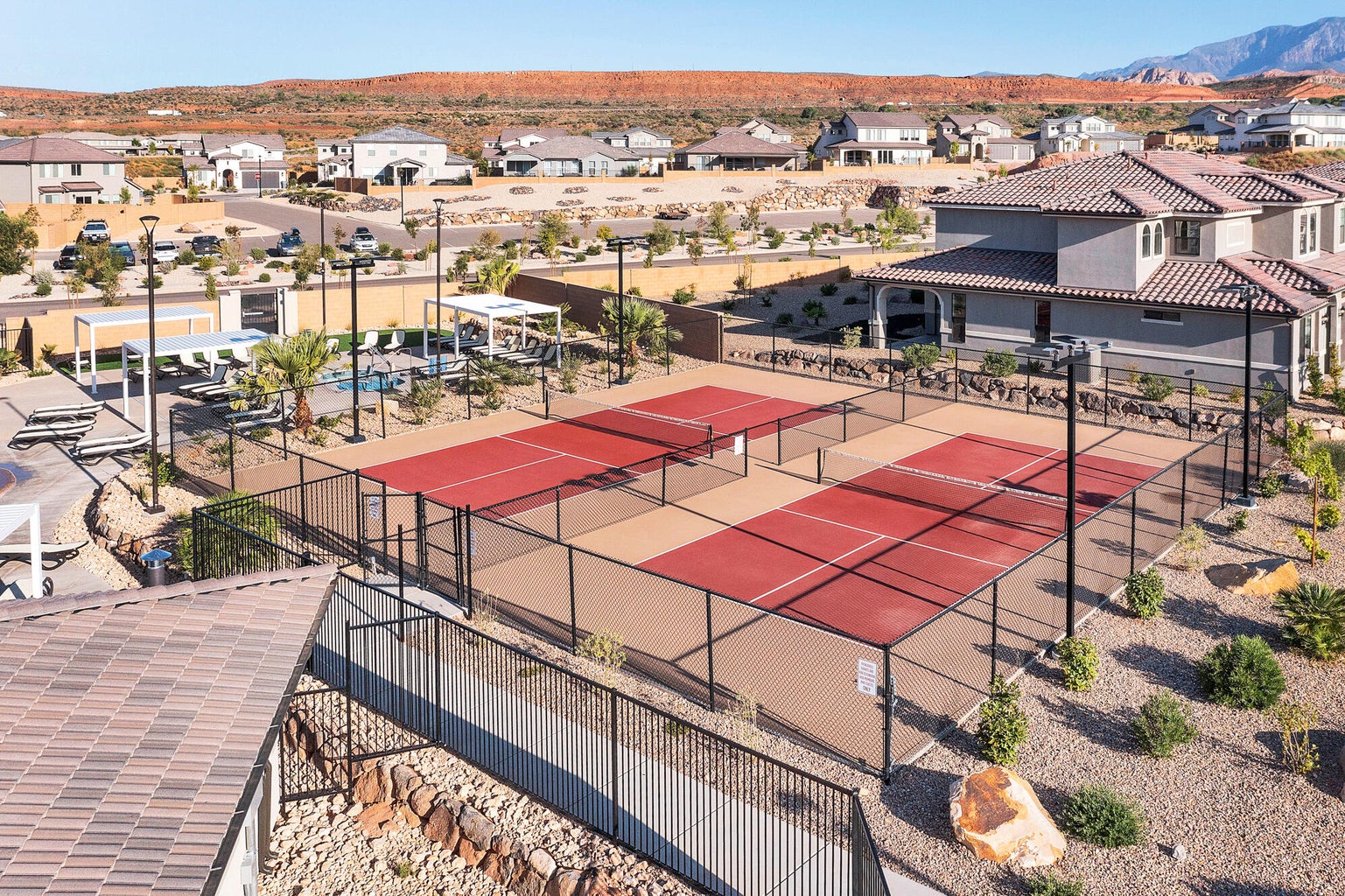 View of tennis court featuring a residential view and a patio area