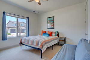 Bedroom with carpet and a ceiling fan