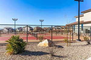 View of tennis court featuring a residential view