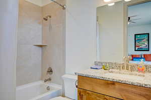 Full bathroom with shower / tub combo, ensuite bathroom, vanity, and ceiling fan