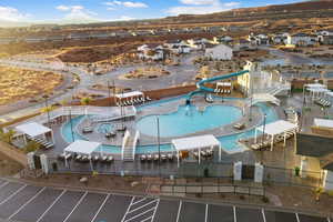 Aerial perspective of suburban area with a pool area and mountains