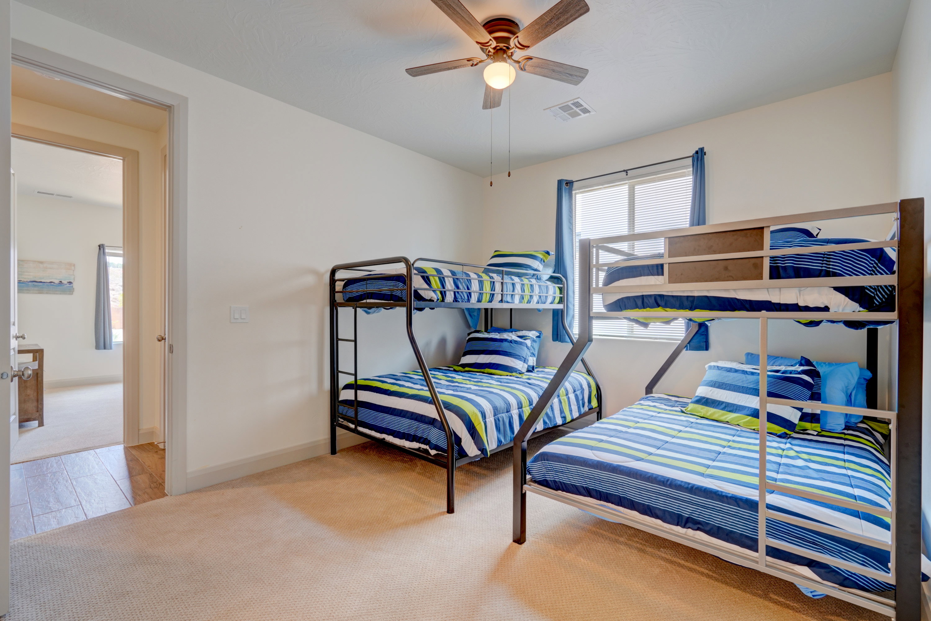 Bedroom featuring light carpet and a ceiling fan
