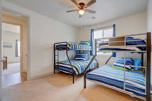 Bedroom featuring light carpet and a ceiling fan