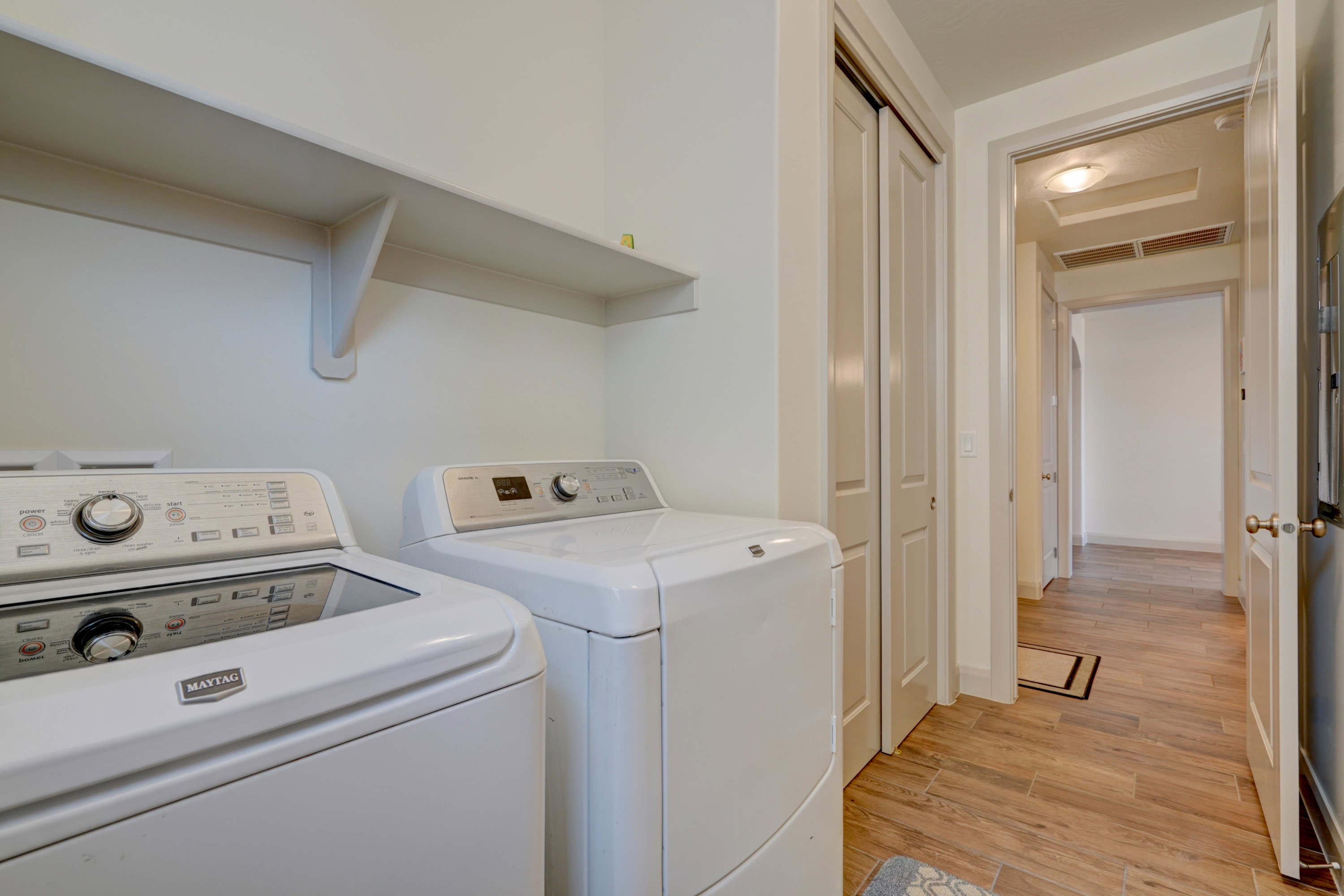 Washroom with light wood-type flooring and washer and dryer