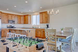 Kitchen with a center island, stainless steel microwave, light wood-style flooring, and recessed lighting