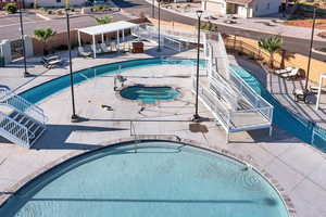 Community pool with a community hot tub and a patio