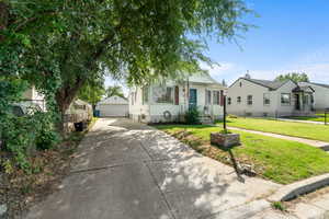 Bungalow with a garage and an outbuilding