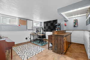 Bar area featuring a textured ceiling and dark countertops