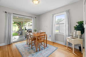 Dining room with light wood finished floors and a textured ceiling