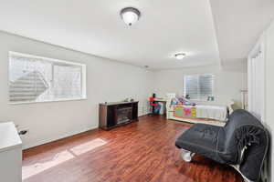 Sitting room with wood finished floors and baseboards
