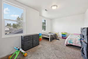 Bedroom with carpet floors and baseboards