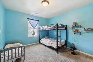 Bedroom with carpet floors and baseboards