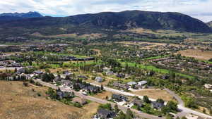 View of property location with mountains and nearby suburban area