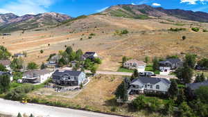 Aerial perspective of suburban area featuring a mountain backdrop