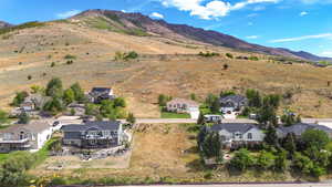 Aerial perspective of suburban area featuring a mountainous background