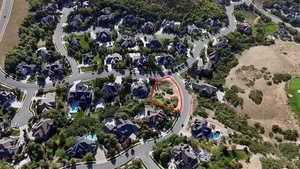 Aerial overview of property's location with nearby suburban area and property parcel outlined - Overhead