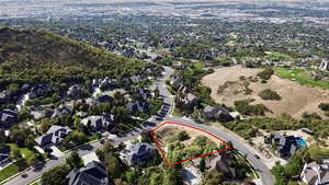 Aerial view of residential area with property parcel outlined showing views to the West