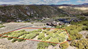 Aerial view of property's location featuring gradual slope, mountain background, property parcel outlined and views to the East