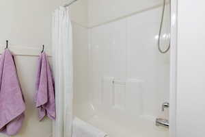Full bathroom with shower / bath combination with curtain