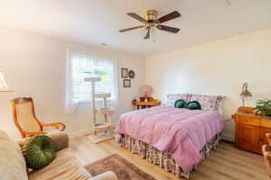 Bedroom featuring wood finished floors and a ceiling fan