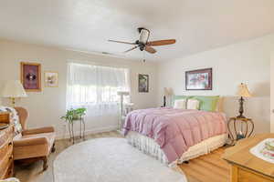 Bedroom featuring wood finished floors and ceiling fan